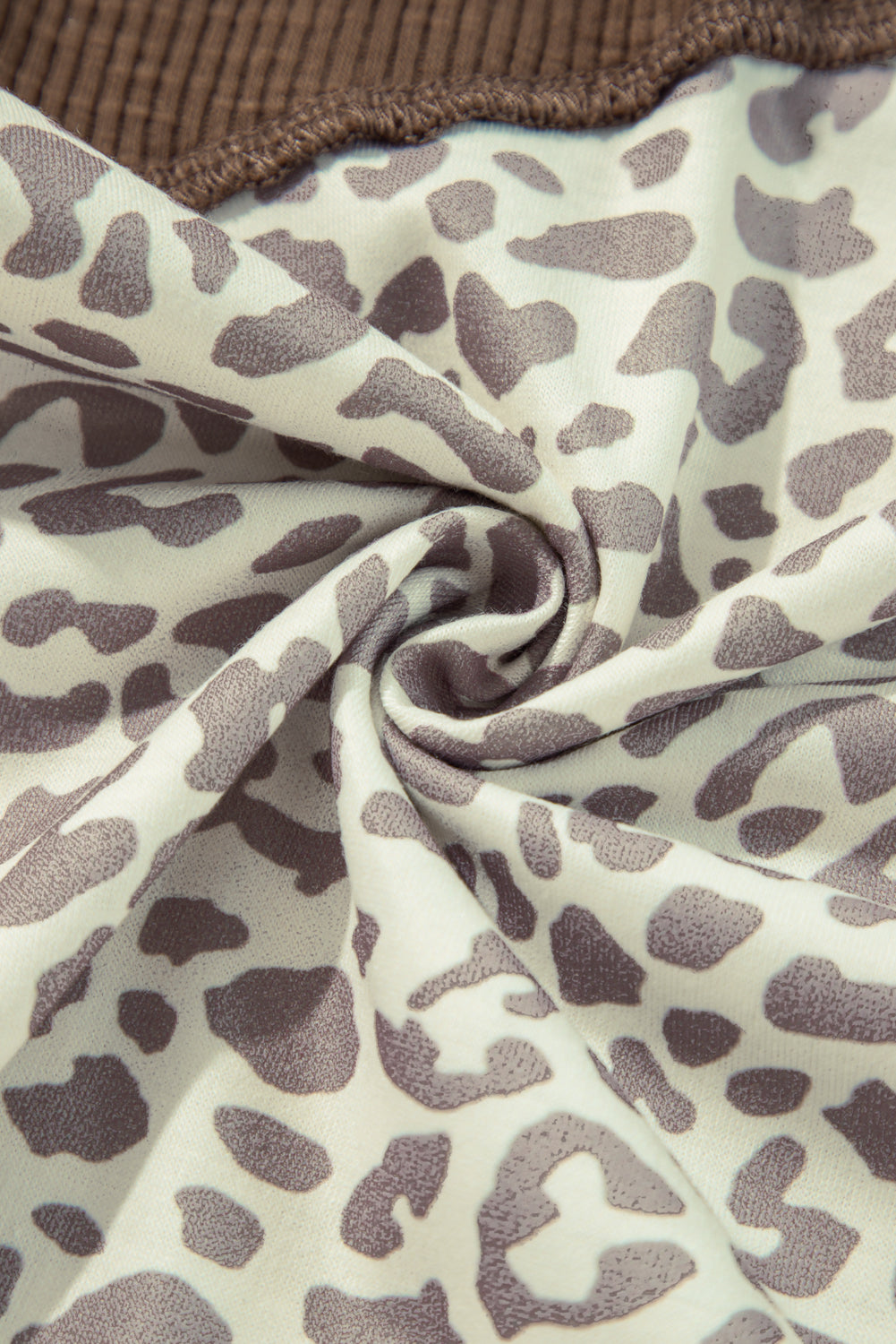 Detailed view of Leopard Ribbed Patchwork Drawstring Hoodie, highlighting its stylish cut and fit.