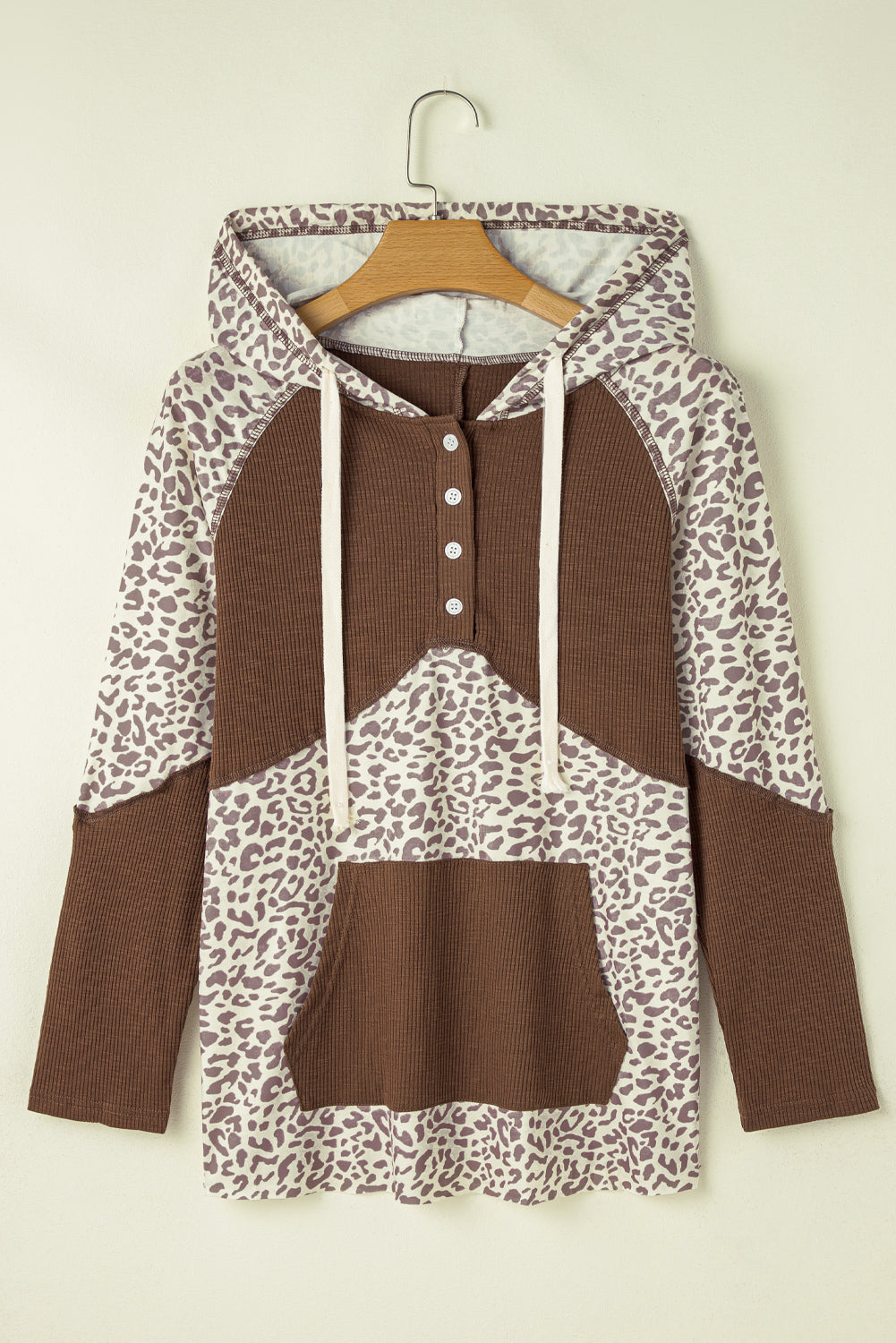 Detailed view of Leopard Ribbed Patchwork Drawstring Hoodie, highlighting its stylish cut and fit.