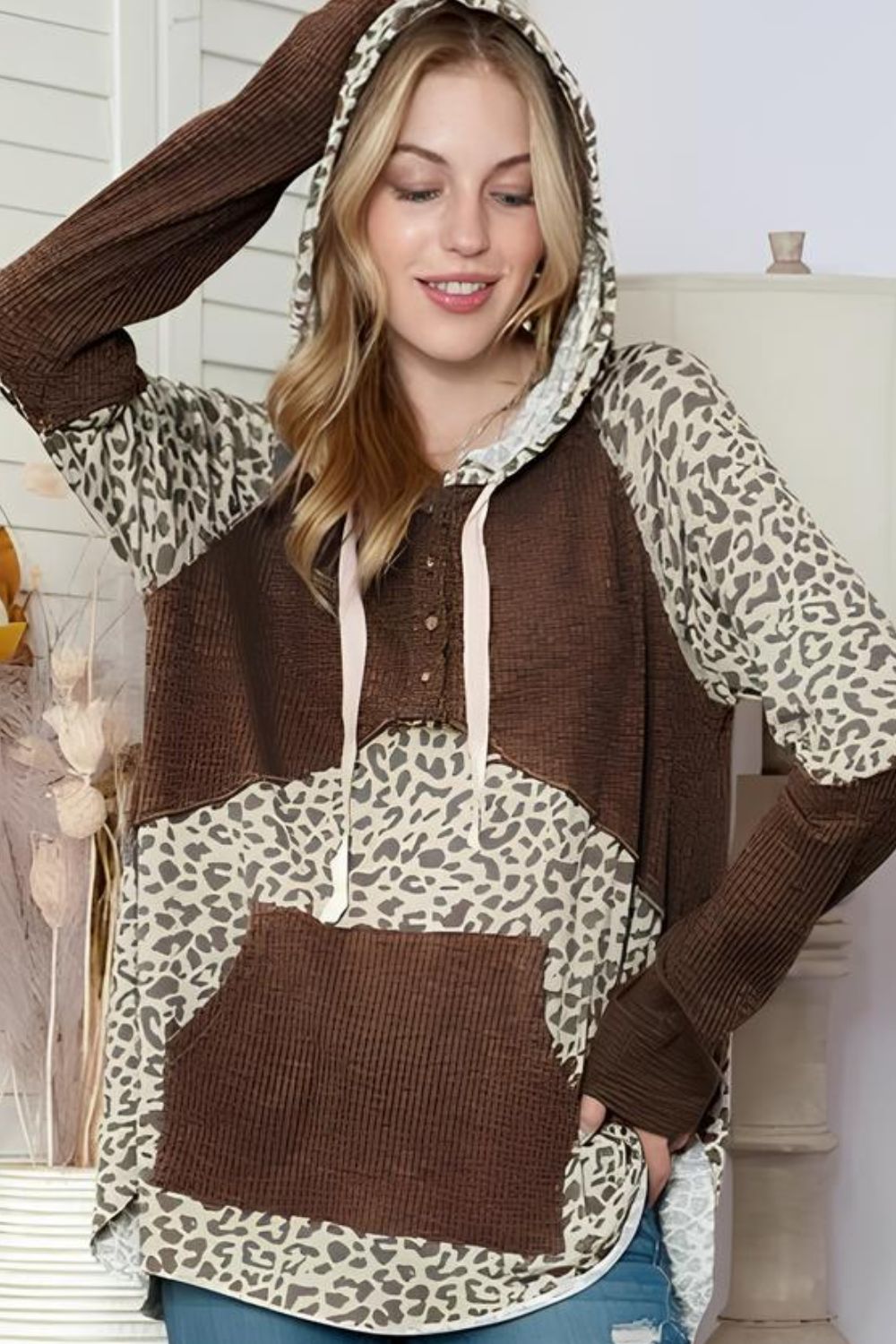 Detailed view of Leopard Ribbed Patchwork Drawstring Hoodie, highlighting its stylish cut and fit.